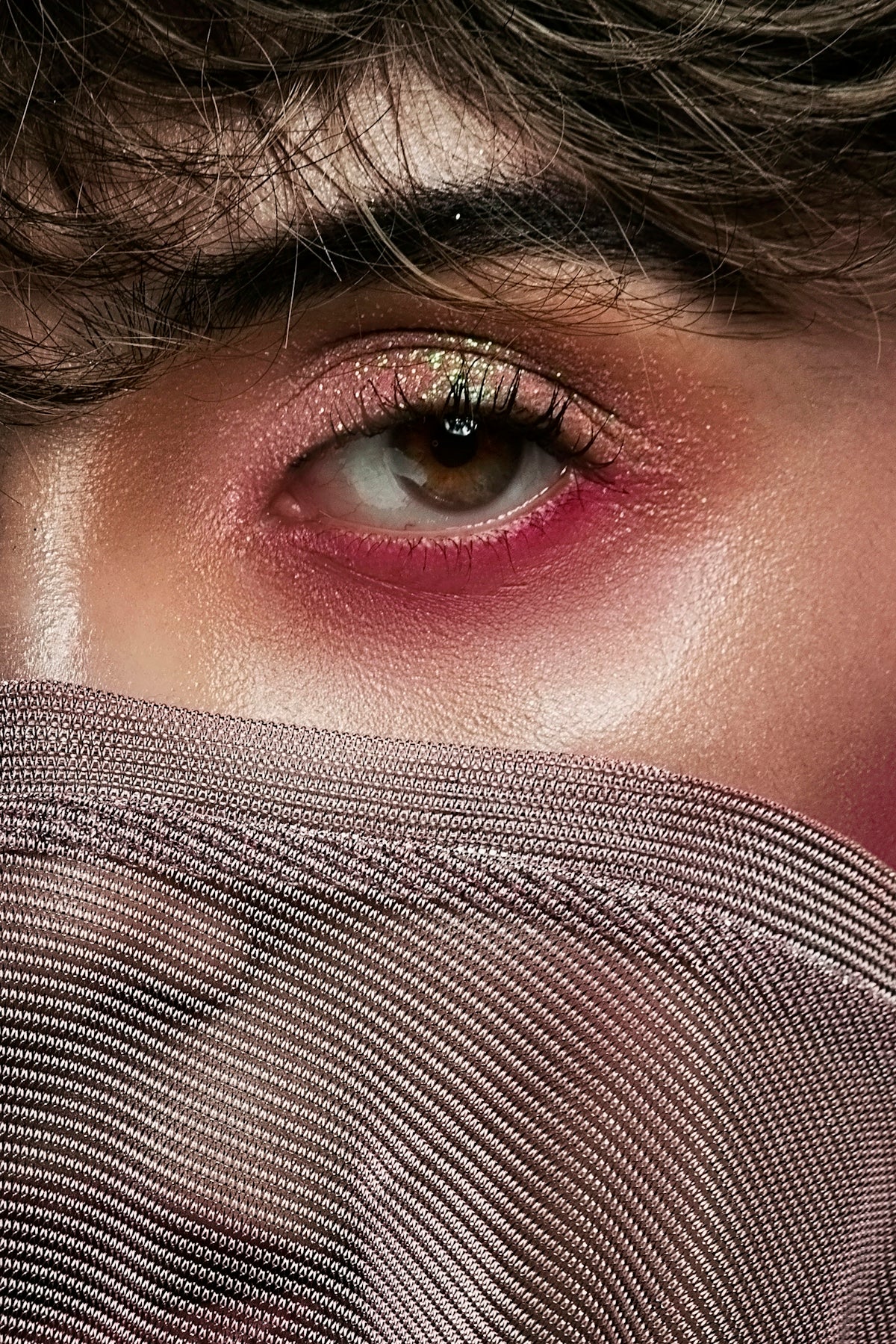 woman covering her face with gray textile